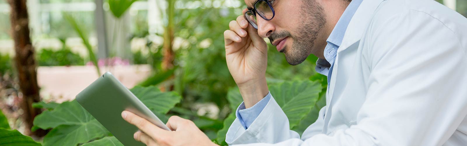 precision farmer using tablet to improve output of his crops