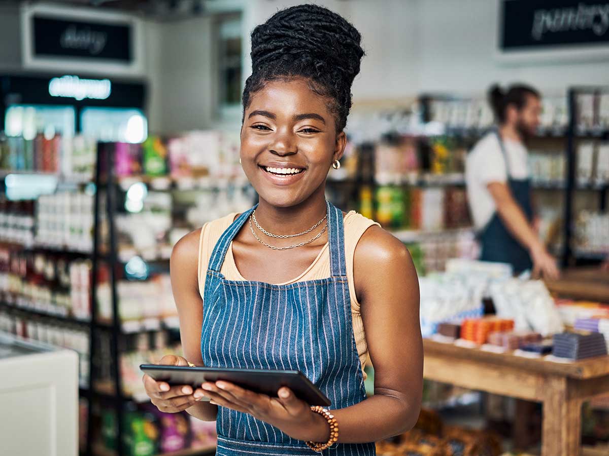 smiling woman in a small scale retail environment