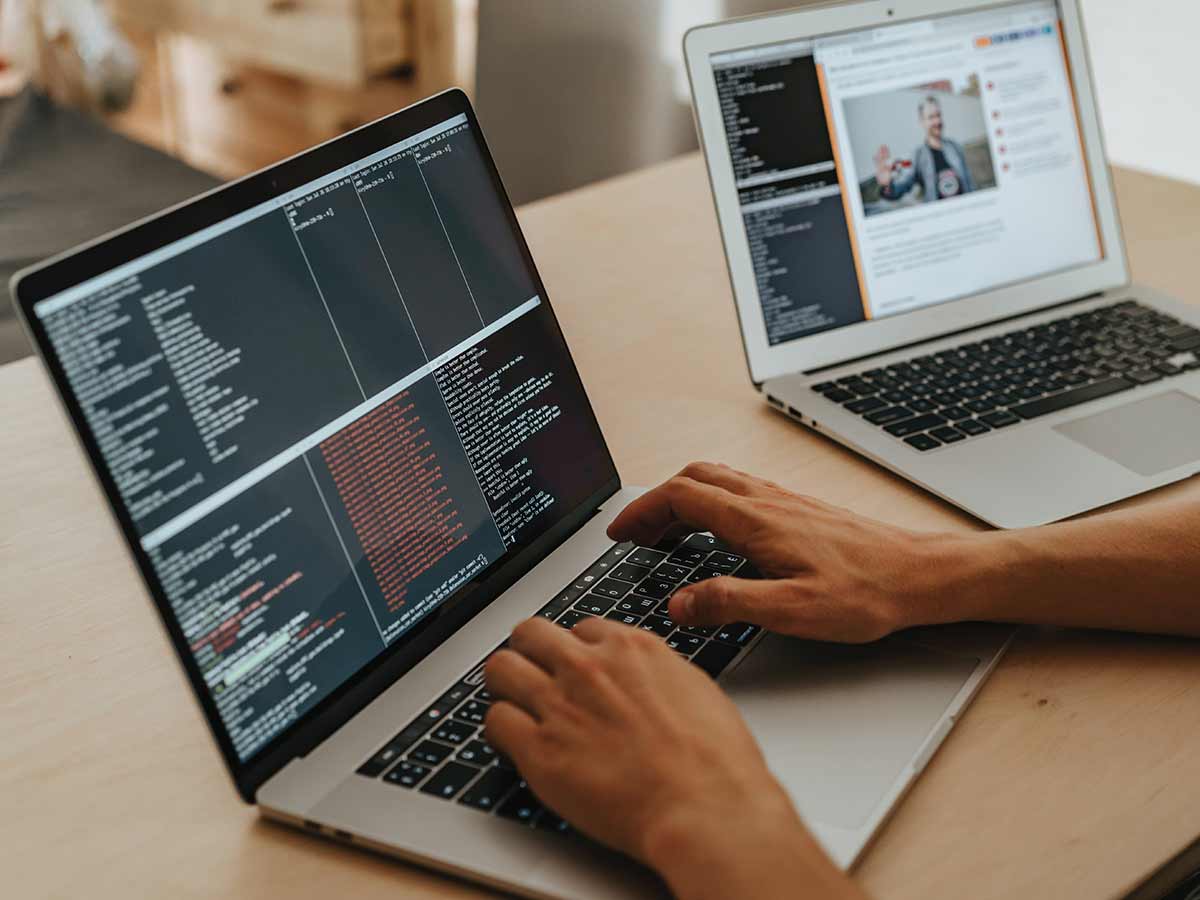 person working on a computer showing lots of code